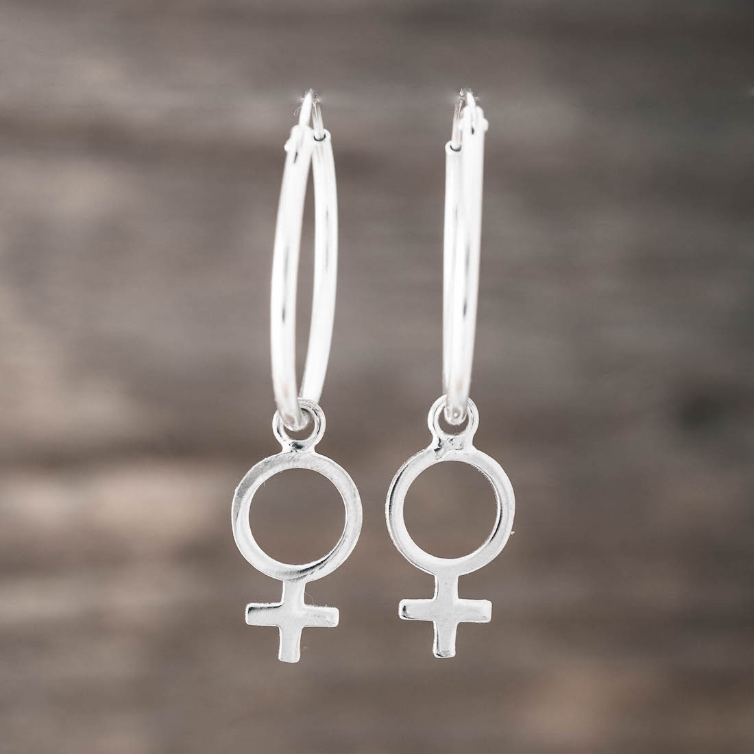 Silver hoop big with a female sign