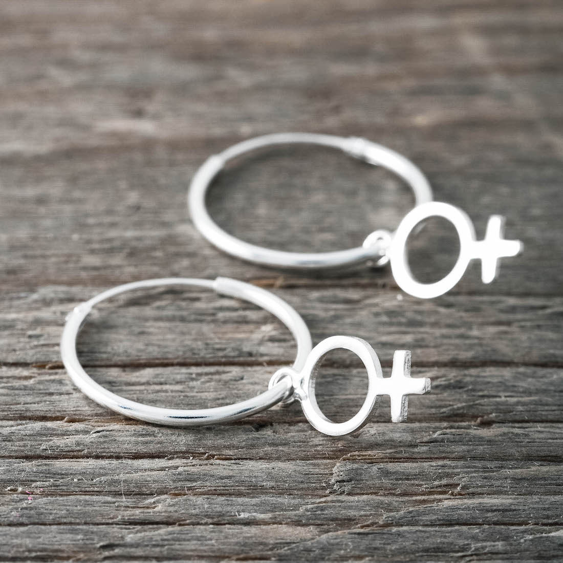 Silver hoop big with a female sign