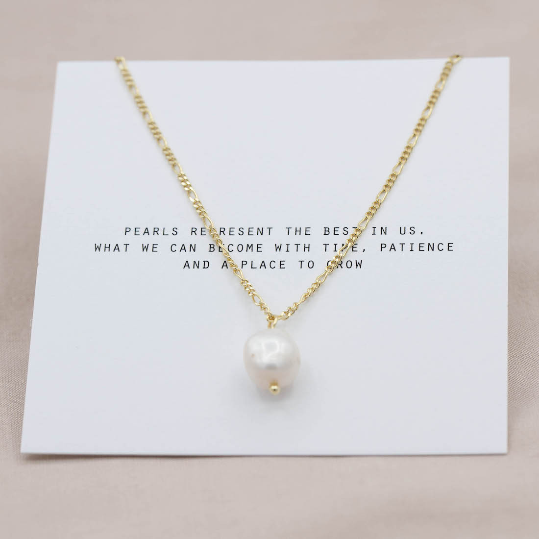 gold necklace with a fresh water pearl