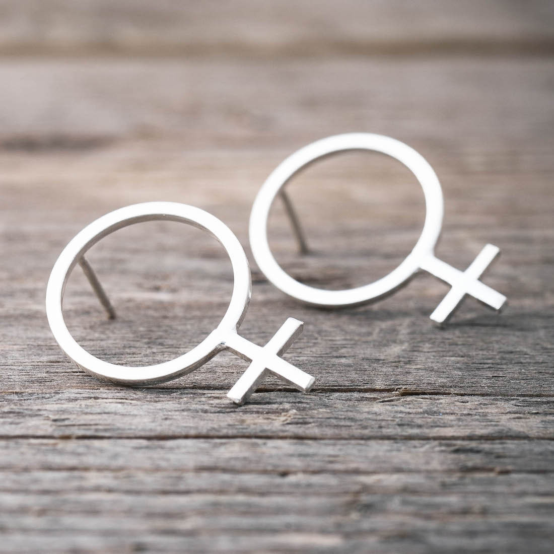 Silver earring big female sign