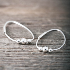 Silver wire drop shape earrings with silver balls