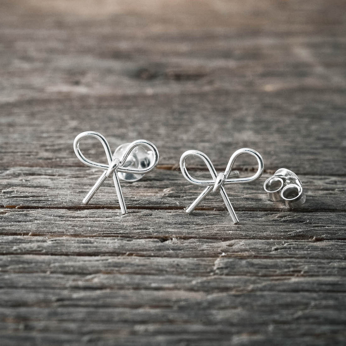 Silver earrings bow