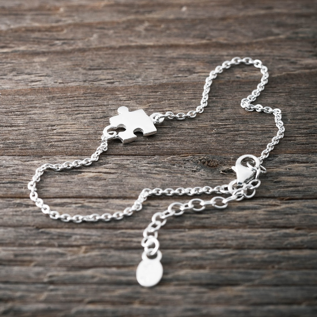 Silverarmband liten pusselbit