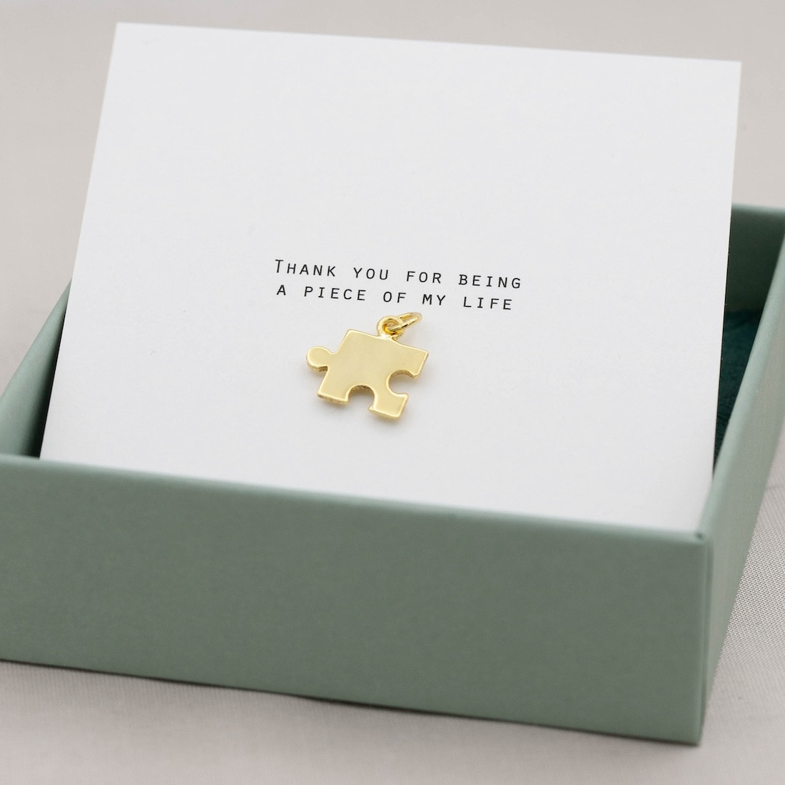 Gold pendent puzzle piece