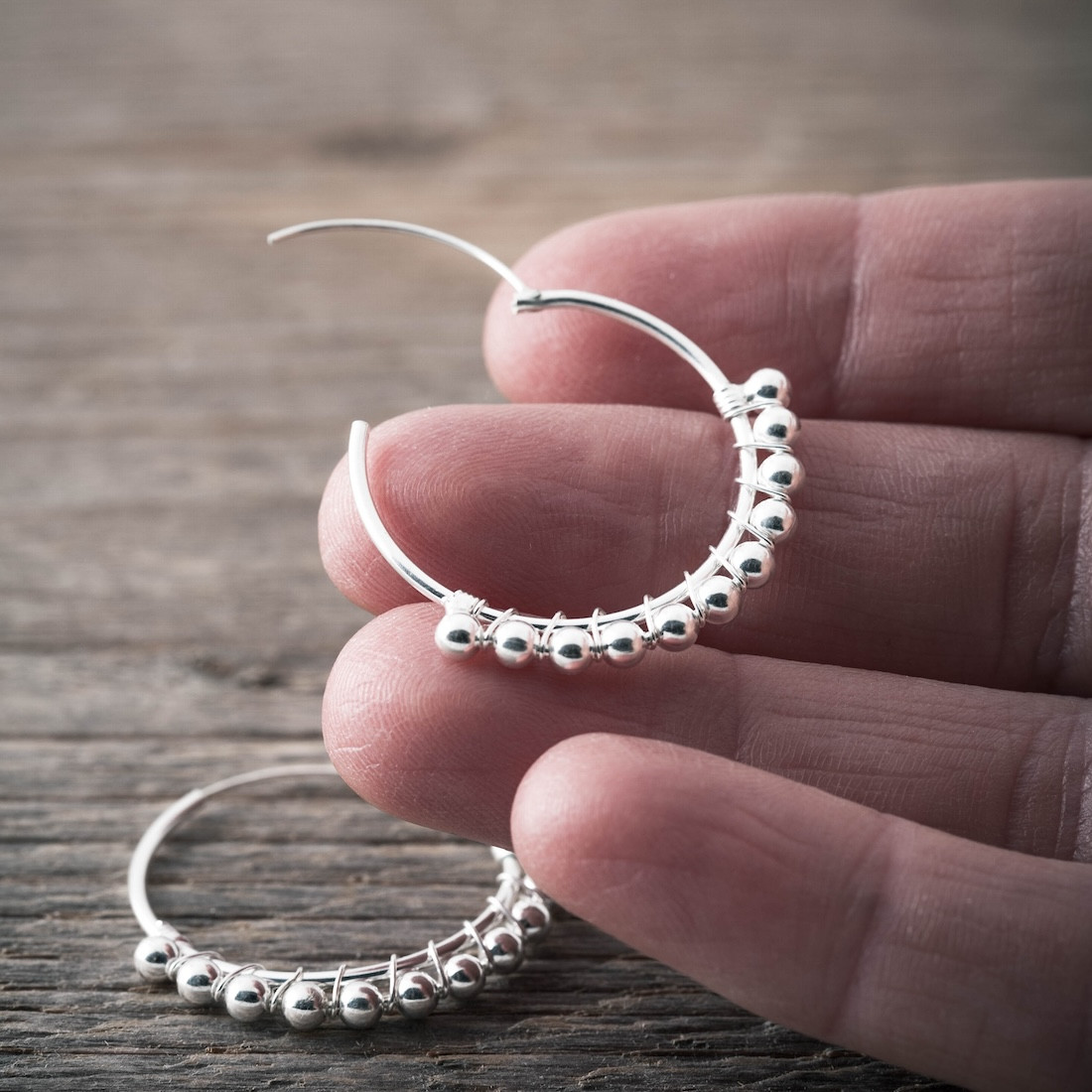 Creole with mini silver balls on a thread