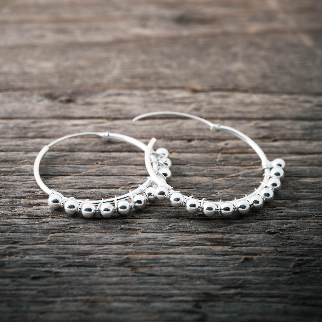 Creole with mini silver balls on a thread