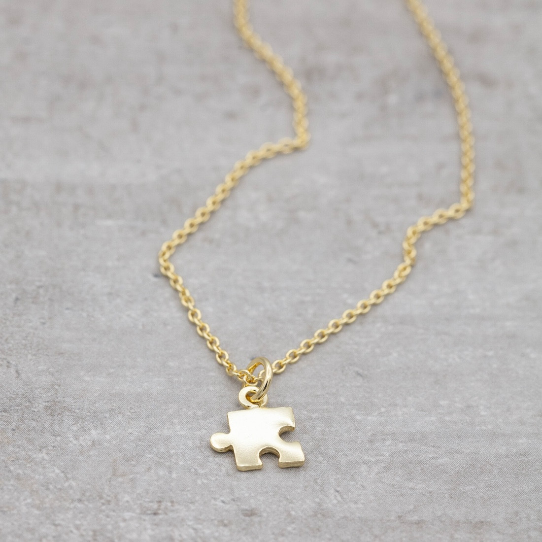 Gold necklace small puzzle piece