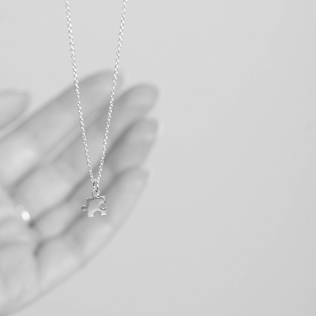 Gold necklace small puzzle piece
